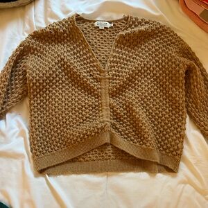 Size xtra small cropped sweater, can adjust length.